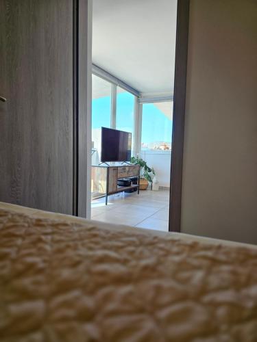 a bedroom with a bed and a view of the ocean at Liberty Roof House in Ermoupoli