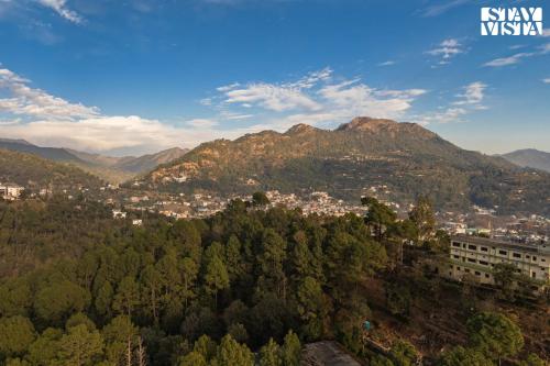 a view of a town in the mountains at StayVista at La Casa Oberoi with Lawn & Mountain View in Bhīm Tāl