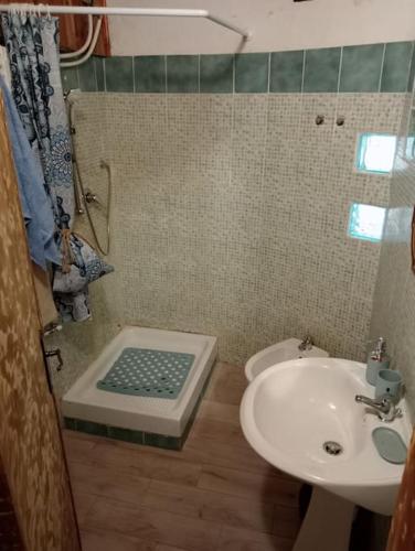 a bathroom with a sink and a toilet and a shower at La Persellina House in Sant' Agata fossili