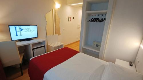 a bedroom with a bed and a television in it at Hotel President in Prato