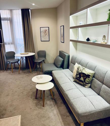 a living room with a couch and tables and chairs at City Zen in Ruse