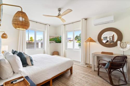 a bedroom with a bed and a desk with a mirror at 3BR Private Pool Retreat 4 Mins Drive by Bocobay in Palm-Eagle Beach