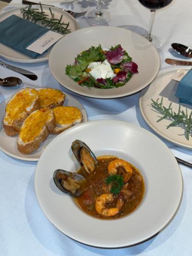 a table with three plates of food on it at The Pink Boutique Hotel in Da Lat