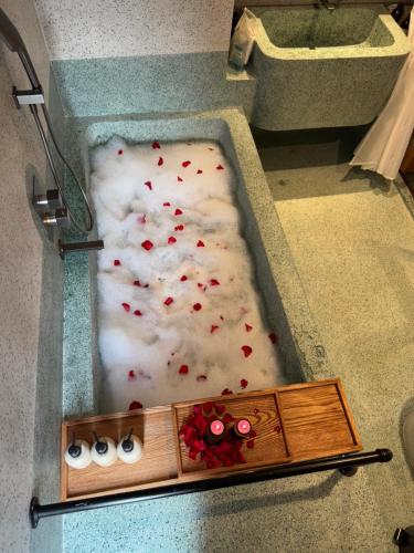 a bath tub filled with white snow and red sprinkles at The Pink Boutique Hotel in Da Lat