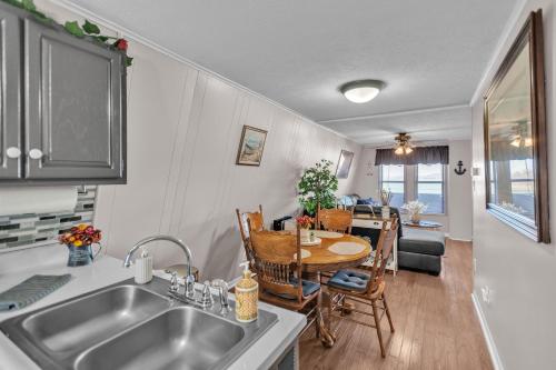 a kitchen with a sink and a table with chairs at Beautiful Lakeview Chateau with Stunning Views home in Rutledge