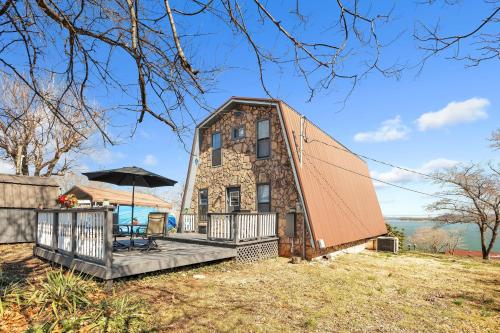 a house with an orange roof and a deck at Beautiful Lakeview Chateau with Stunning Views home in Rutledge