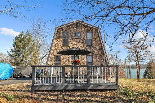 a house with an umbrella in front of it at Beautiful Lakeview Chateau with Stunning Views home in Rutledge