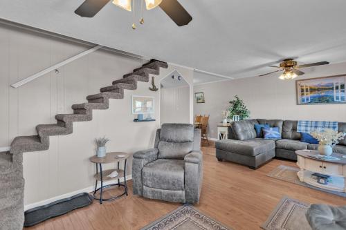 a living room with a staircase and a couch at Beautiful Lakeview Chateau with Stunning Views home in Rutledge