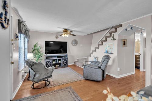 a living room with two chairs and a tv at Beautiful Lakeview Chateau with Stunning Views home in Rutledge