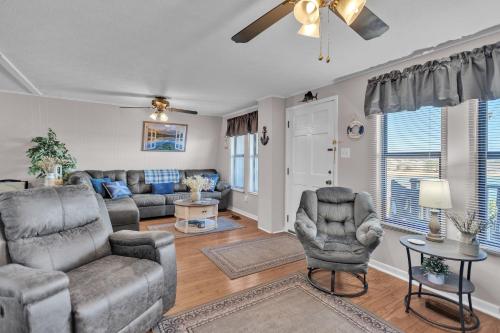 a living room with a couch and chairs and a ceiling fan at Beautiful Lakeview Chateau with Stunning Views home in Rutledge