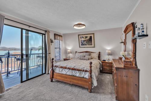 a bedroom with a bed and a balcony at Beautiful Lakeview Chateau with Stunning Views home in Rutledge