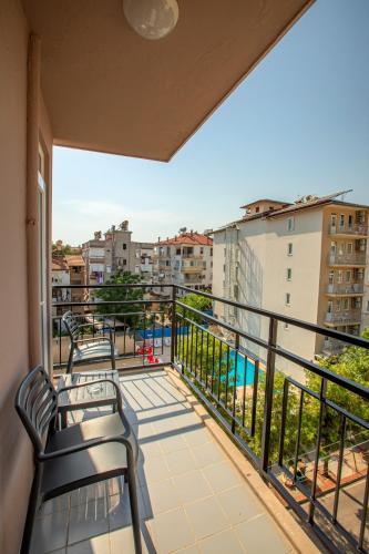 a balcony with benches and a view of a city at Perle Apart Hotel in Alanya