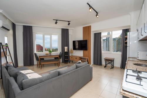 a living room with a couch and a table at B lackstone Homes in Aksu
