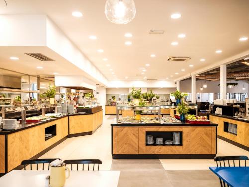 a restaurant with counters and tables and a cafeteria at Zaton Holiday Resort in Nin