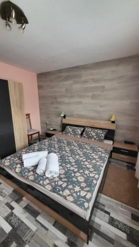 a bedroom with a bed with two pillows on it at Апартамент за гости ТАРА in Ruse