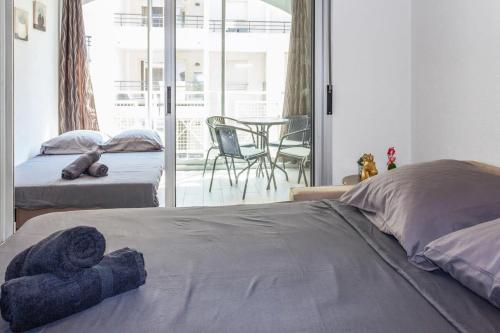 une chambre avec deux lits et une table et des chaises dans l'établissement Le Bricka - Hypercentre - Cosy - 2 min from the sea, à Antibes