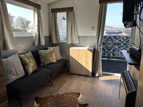 a living room with a couch and a window at RBR 1463 - Beach Resort Kamperland in Kamperland