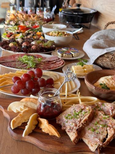 a table with many plates of food on it at Villa La Roca Garden and Spa in Kościelisko