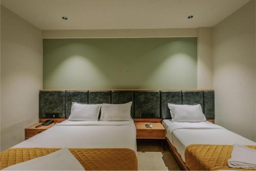 Hotel Beverly Plaza Kozhikodeにあるベッド