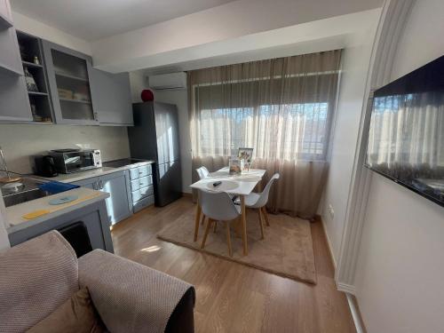 a small kitchen with a table and chairs in a room at D&D Apartments in Tirana
