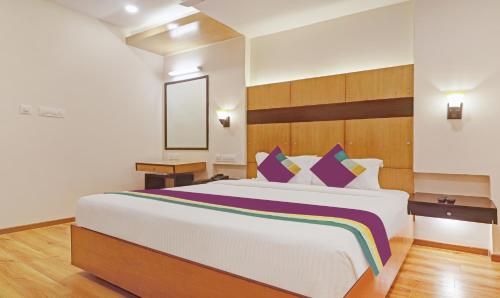 a bedroom with a large bed in a room at Treebo Premium Seven Lake View in Hyderabad