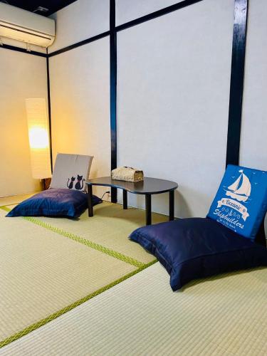 a room with two chairs and a table in it at Sakura桜ノ宮ヴィラ in Osaka