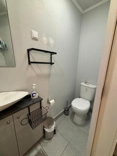a bathroom with a white toilet and a sink at Cc39-Q2 in Funchal