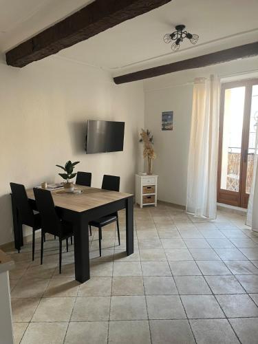 a dining room with a table and chairs at 2 rooms, old town in Antibes