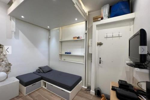 Cette petite chambre dispose d'un banc et d'une télévision. dans l'établissement Flexliving - Studio - Gérard, à Paris