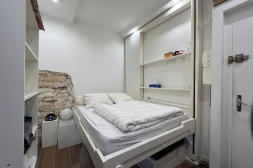Cette petite chambre comprend un lit. dans l'établissement Flexliving - Studio - Gérard, à Paris