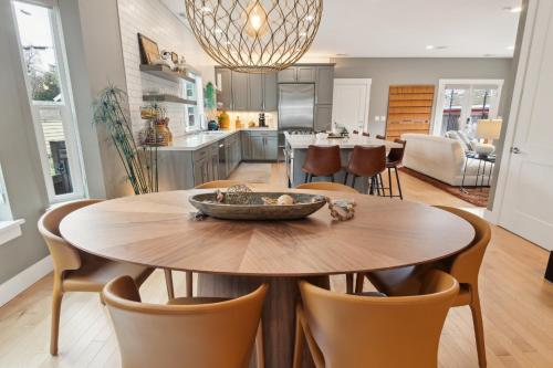 a kitchen and dining room with a table and chairs at Spacious Family Retreat - Media Room & Patio home in Seattle