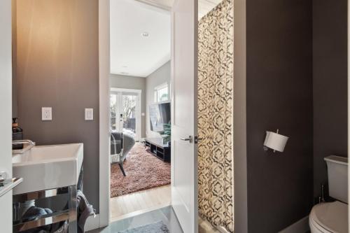 a bathroom with a sink and a toilet and a mirror at Spacious Family Retreat - Media Room & Patio home in Seattle