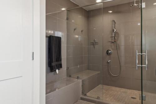 a bathroom with a shower with a glass door at Spacious Family Retreat - Media Room & Patio home in Seattle