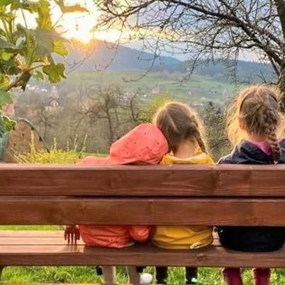 three children sitting on a bench looking at the view at Chata pod Mogielicą komfortowe pokoje z widokiem na Mogielicę 1000m od tras wokół góry Mogielica in Słopnice