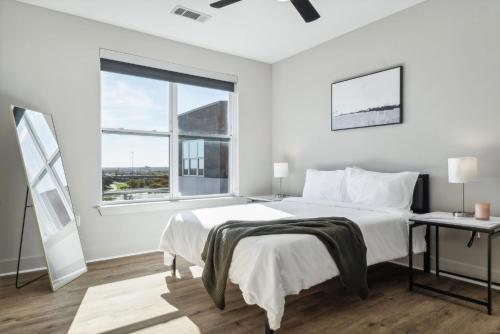 a white bedroom with a large bed and a window at Indie Deep Ellum in Dallas in Dallas