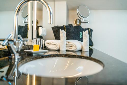 a bathroom with a sink and a mirror at Berghotel Rehlegg in Ramsau