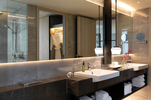 a bathroom with a sink and a mirror at Ascott Thonglor Bangkok in Bangkok