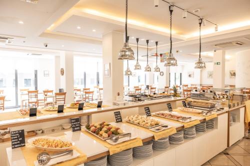 a buffet line with many plates of food at Hotel Principe in Cattolica