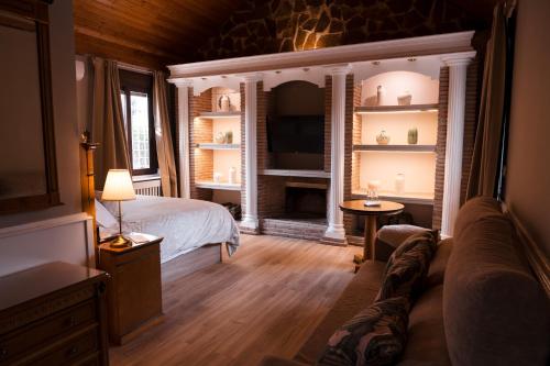 a bedroom with a bed and a fireplace at Vega de la Reina in Jaén