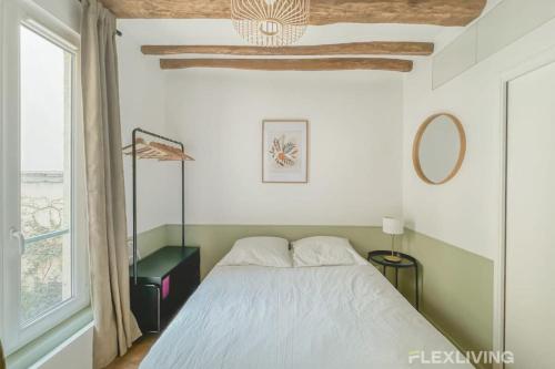 une chambre avec un lit et une fenêtre dans l'établissement Flexliving - Studio - Petits Carreaux - Paris 2, à Paris