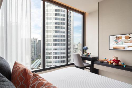 a hotel room with a view of a skyscraper at Ascott Thonglor Bangkok in Bangkok