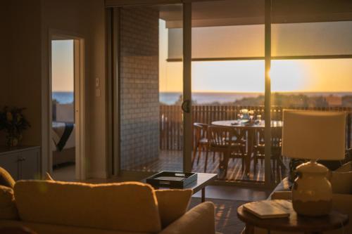 a living room with a view of a balcony at Sea Dunes Luxury Apartments in Moana