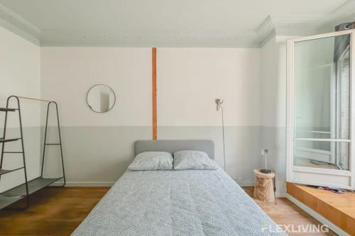 - une chambre avec un lit, une échelle et une fenêtre dans l'établissement Flexliving - whole flat - Hameau, à Paris