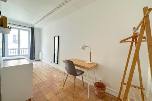 - une cuisine avec un bureau et une chaise dans la chambre dans l'établissement Flexliving - whole flat - Echiquier, à Paris