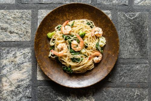 a bowl of pasta with shrimp on a table at Villa Mossa Ambalangoda Boutique villa in Ambalangoda