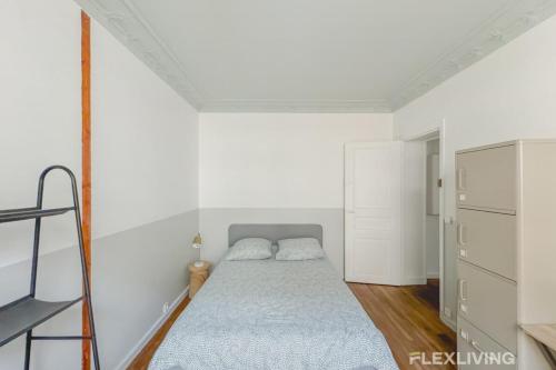 a small bedroom with a bed and a ladder at Flexliving - room - Paris 15 in Paris