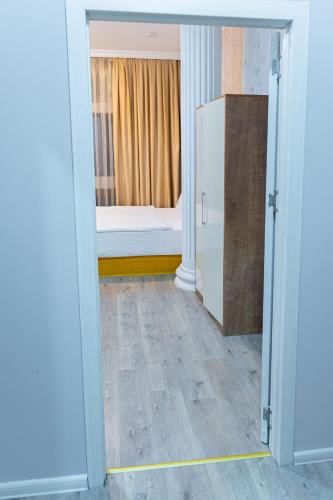 a room with a bedroom with a bed and a door at Square Boutique Hotel in Baku