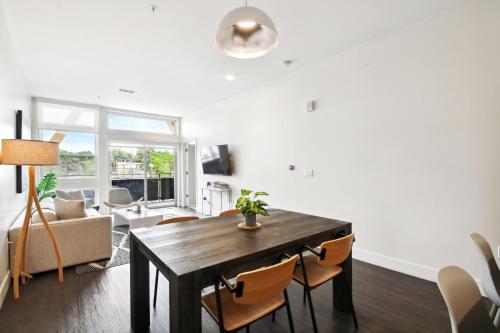 a living room with a wooden table and chairs at 2880 Japandi Minimalism at Espadin in Denver