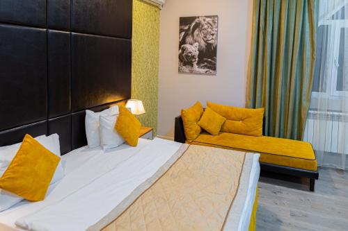 a hotel room with a bed and a couch at Square Boutique Hotel in Baku