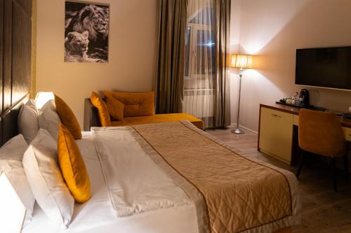 a hotel room with a bed and a television at Square Boutique Hotel in Baku